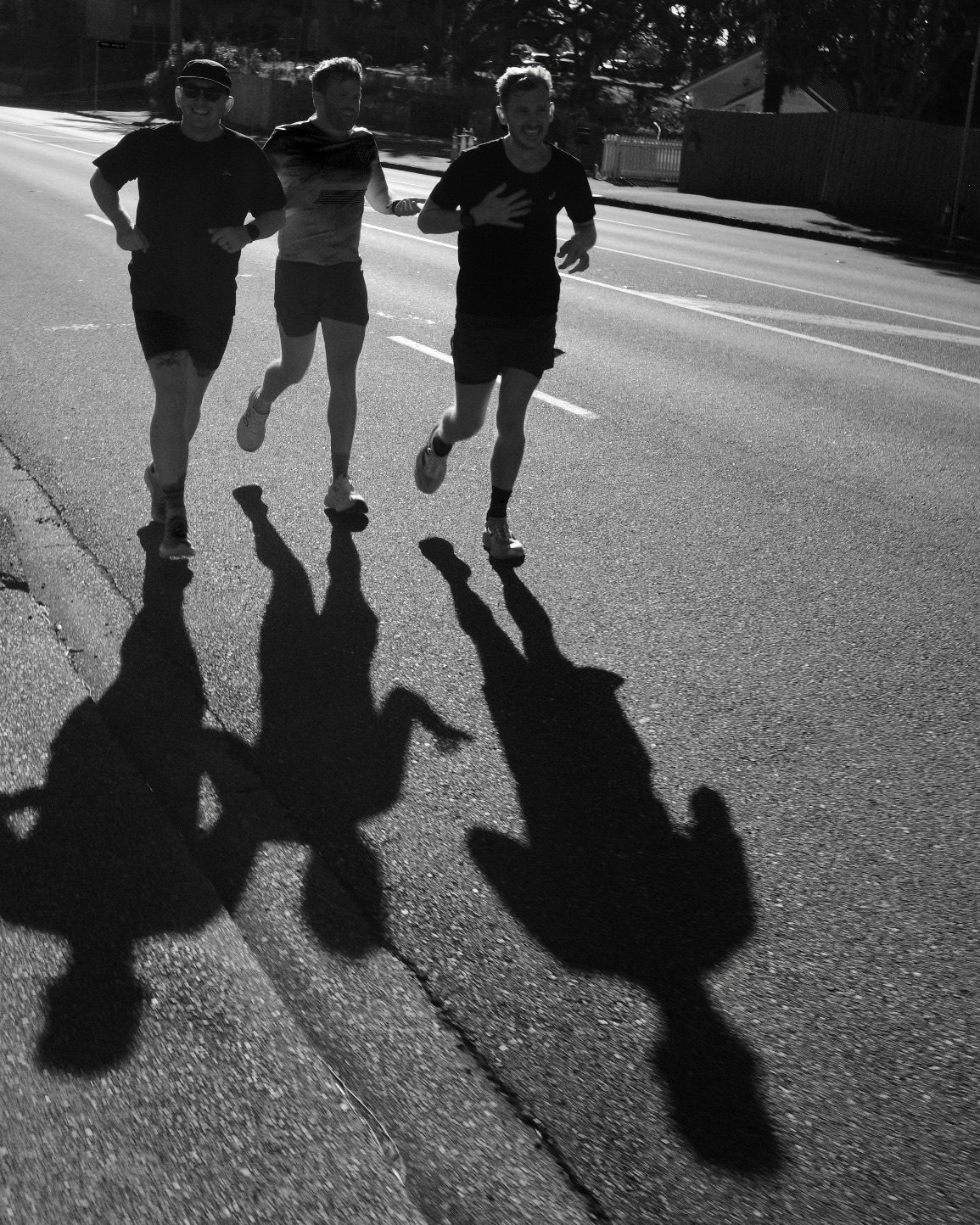 Three Beer Jerk Run Club runners on an Auckland street.
